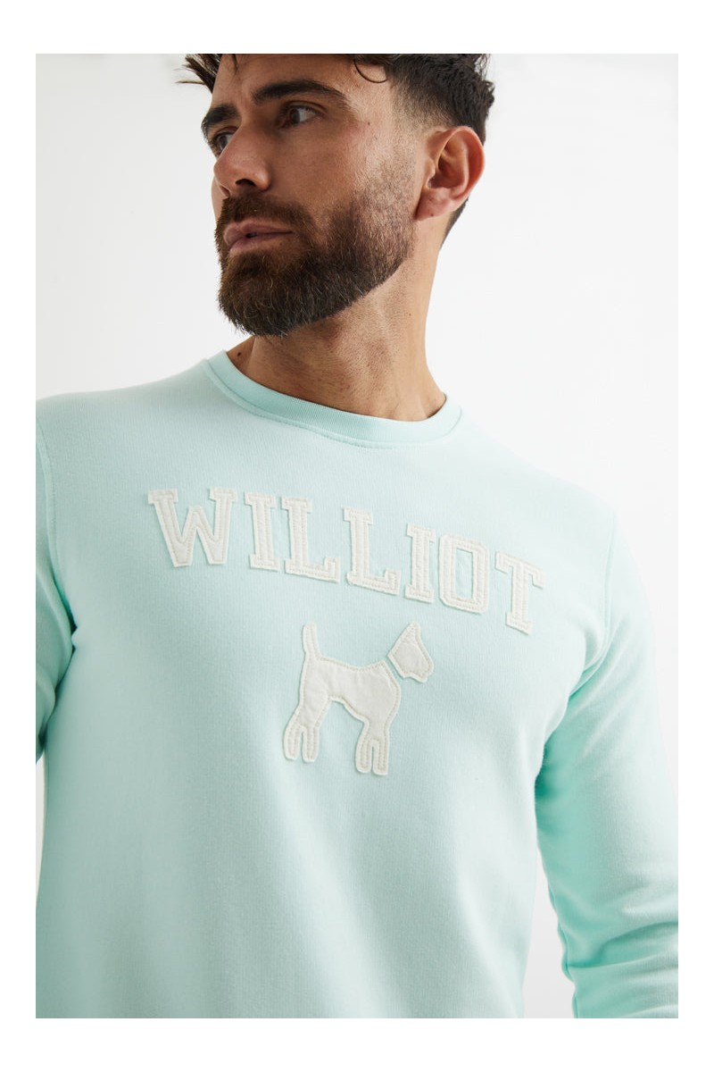 Sudadera turquesa de Williot con logo tipo parche en el pecho. Ideal para looks casuales con un punto distintivo 🐶✨  2