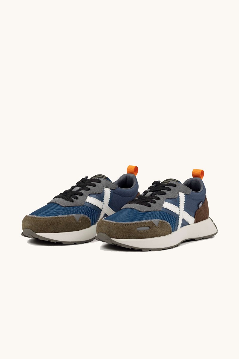  Zapatilla de Munich con diseño retro running, líneas depuradas y un estilo que combina herencia y modernidad. 