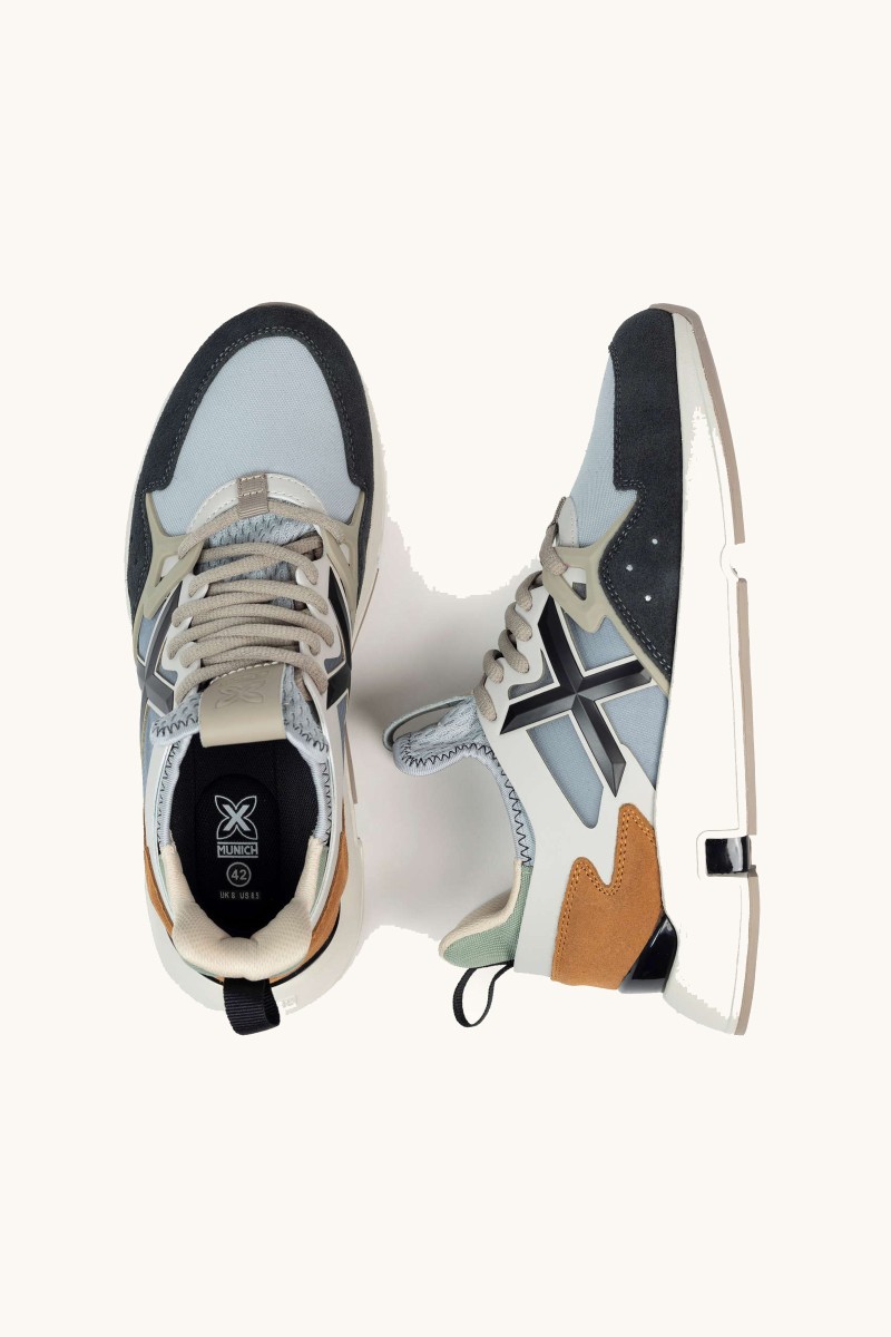  Zapatilla de Munich con diseño innovador, mezcla de materiales y un estilo que fusiona herencia deportiva y tendencia. 