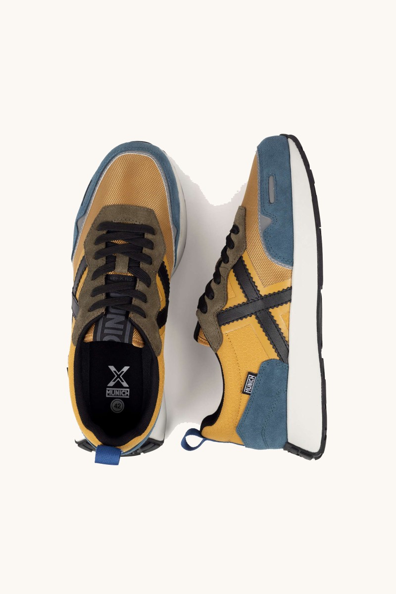  Zapatilla Munich con silueta running y detalles sofisticados. Elegancia deportiva con espíritu retro. 