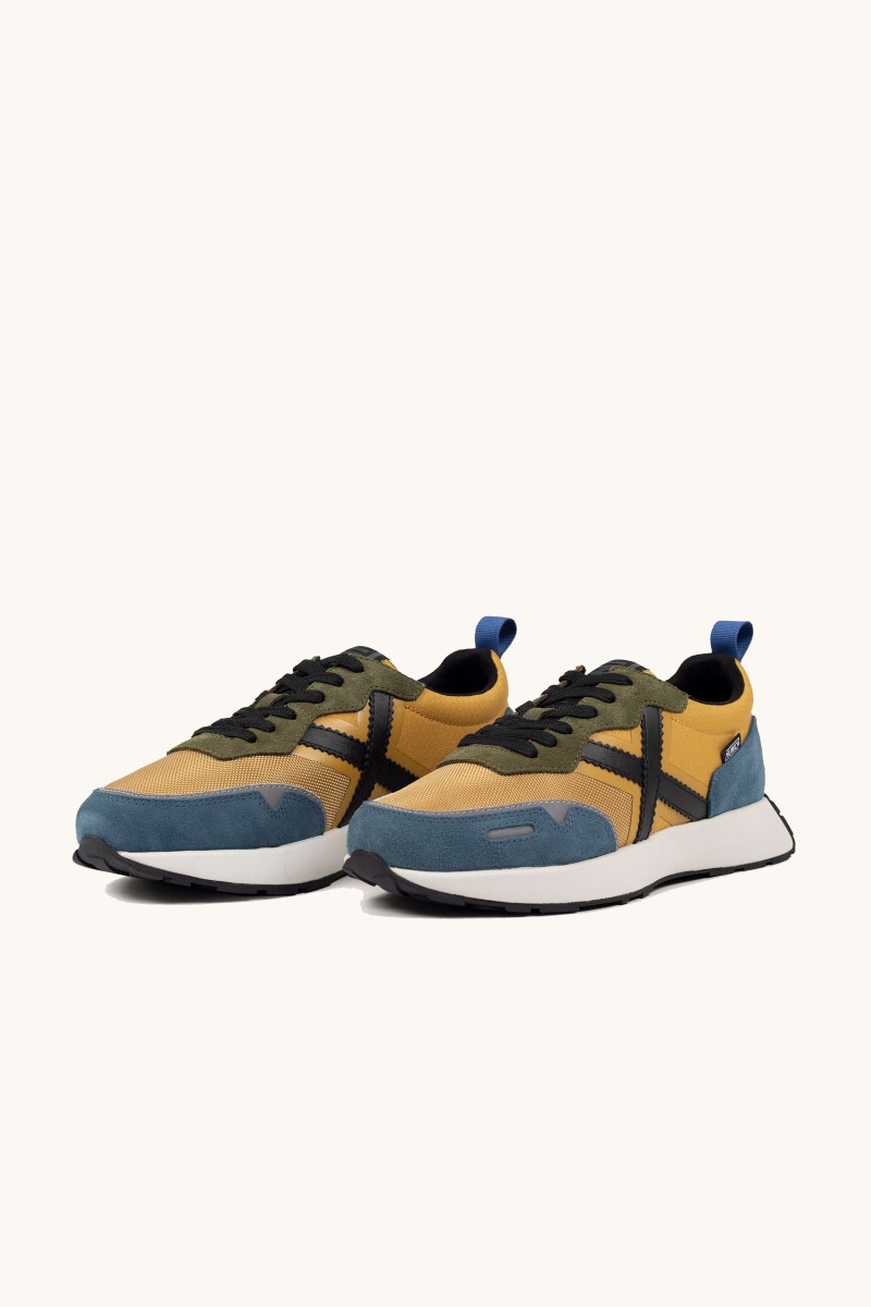  Zapatilla Munich con silueta running y detalles sofisticados. Elegancia deportiva con espíritu retro. 