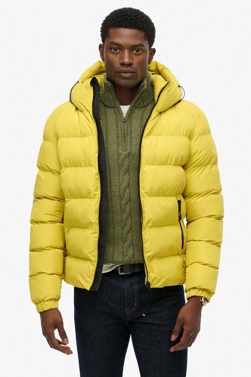  Chaqueta acolchada con capucha y diseño deportivo, perfecta para el frío gracias a su aislamiento ligero y su estilo urbano. 