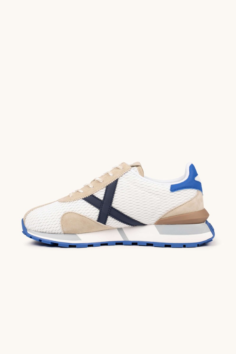  Zapatillas Munich retro con rejilla transpirable y detalles en color, perfectas para looks urbanos con estilo deportivo y comodidad diaria. 
