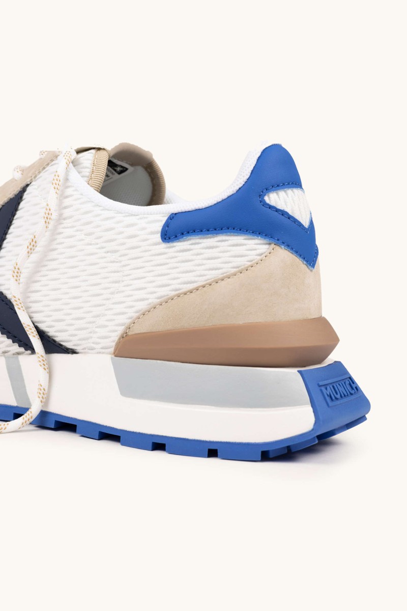  Zapatillas Munich retro con rejilla transpirable y detalles en color, perfectas para looks urbanos con estilo deportivo y comodidad diaria. 