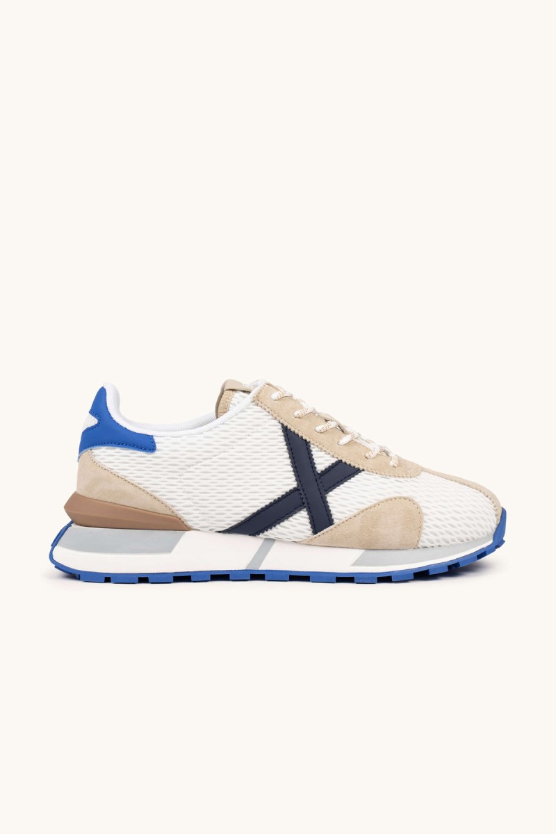  Zapatillas Munich retro con rejilla transpirable y detalles en color, perfectas para looks urbanos con estilo deportivo y comodidad diaria. 