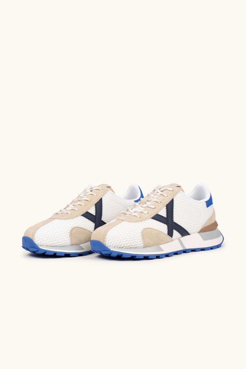  Zapatillas Munich retro con rejilla transpirable y detalles en color, perfectas para looks urbanos con estilo deportivo y comodidad diaria. 