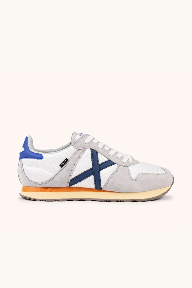  Zapatillas Munich en blanco y gris con estilo retro running, ideales para looks urbanos cómodos y versátiles. 