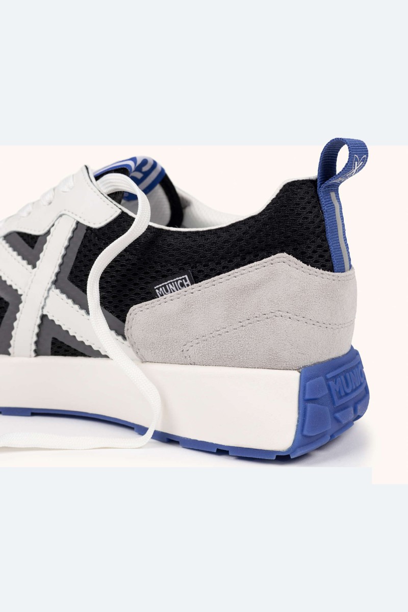 Zapatillas Munich en blanco, negro y gris con estilo deportivo elegante, ideales para looks urbanos cómodos y versátiles. 