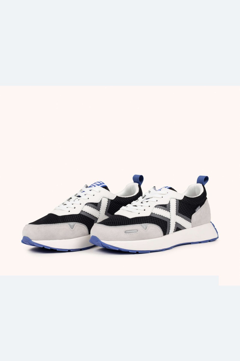  Zapatillas Munich en blanco, negro y gris con estilo deportivo elegante, ideales para looks urbanos cómodos y versátiles. 