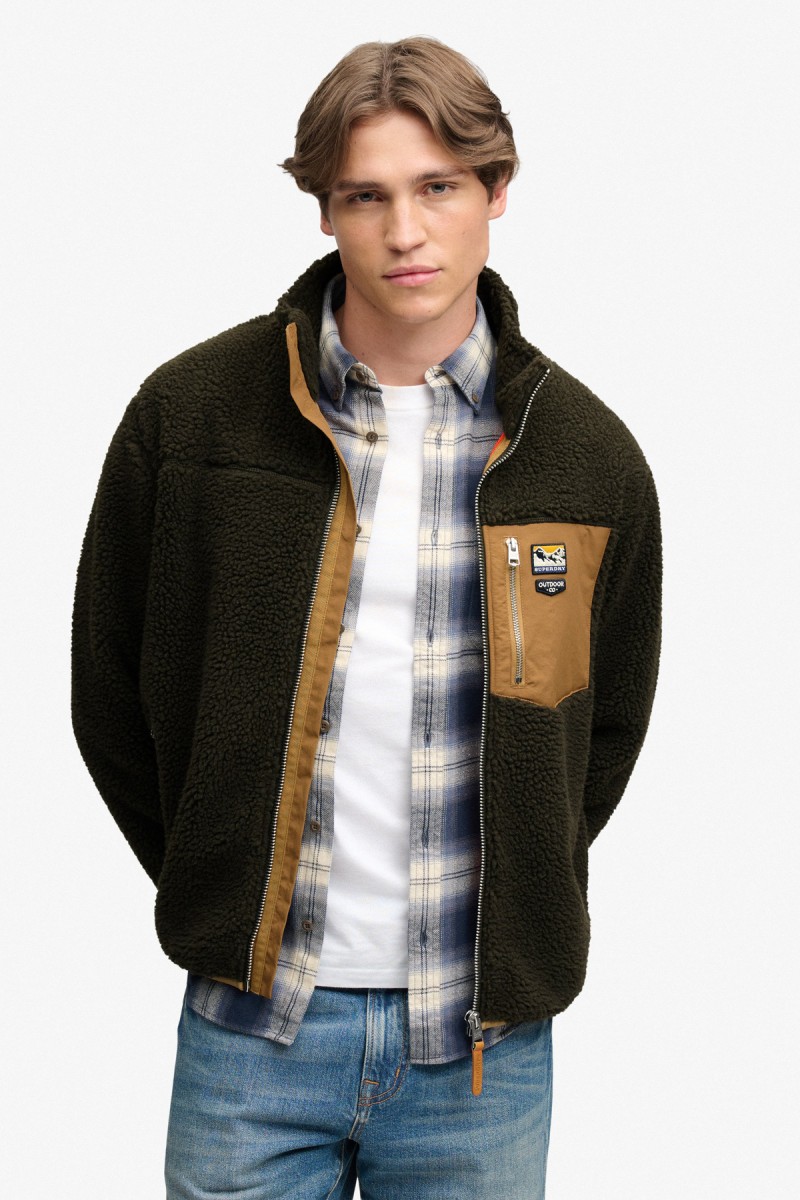  Forro polar Superdry para hombre con diseño de inspiración retro, corte Relaxed Fit y cierre completo de cremallera. Una prenda versátil para el entretiempo con cuello alto y tres bolsillos exteriores. 